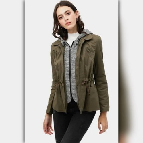 Woman wearing a green jacket with a white background