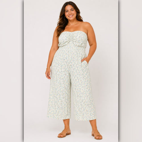 Woman wearing a strapless floral jumpsuit on a white background