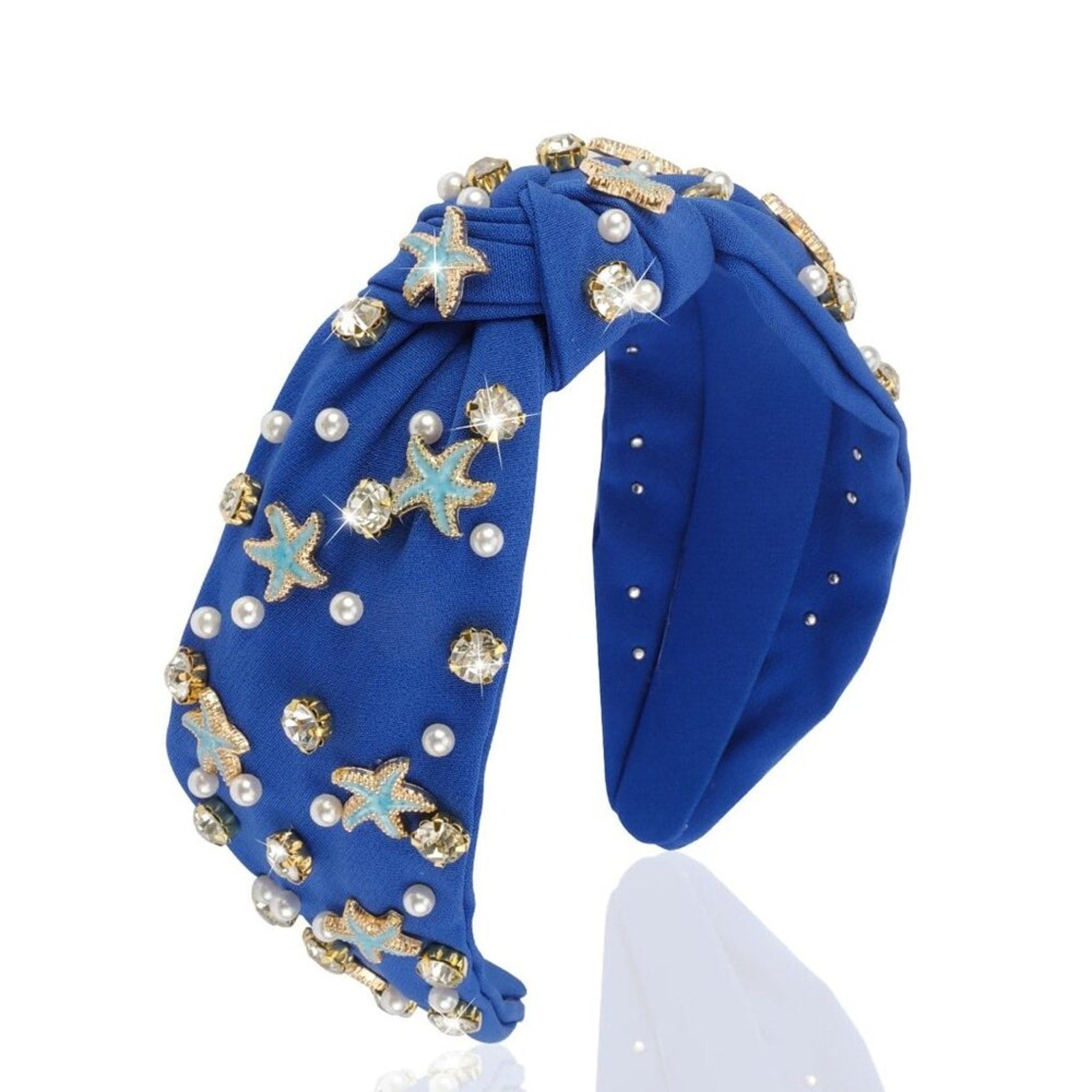 Blue headband with starfish and pearl embellishments on a white background