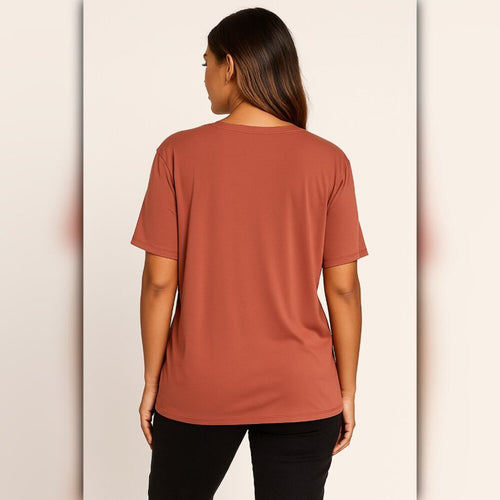 Person wearing a brown t-shirt on a beige background
