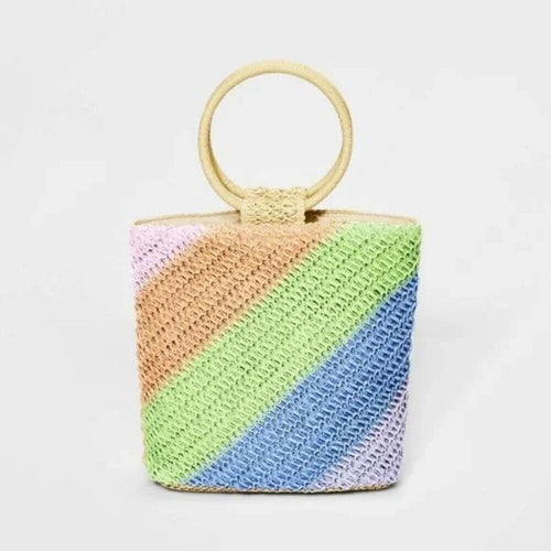 Colorful woven handbag with a wooden handle on a white background