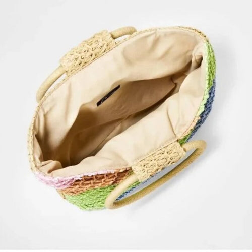 Colorful woven basket with a textured lid on a light gray background