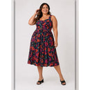 Woman wearing a colorful floral dress on a white background