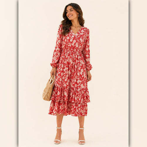 Woman wearing a red floral dress holding a straw bag on a white background