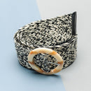 Black and white patterned belt with a decorative buckle on a light blue background