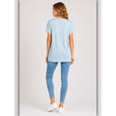 Woman wearing a light blue t-shirt and jeans on a white background