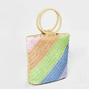 Colorful woven handbag with a geometric pattern on a light gray background