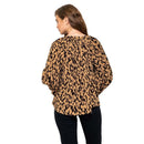 Woman wearing a leopard print top on a white background