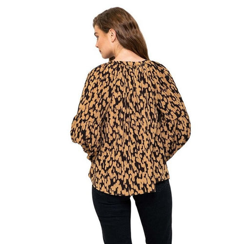 Woman wearing a leopard print top on a white background