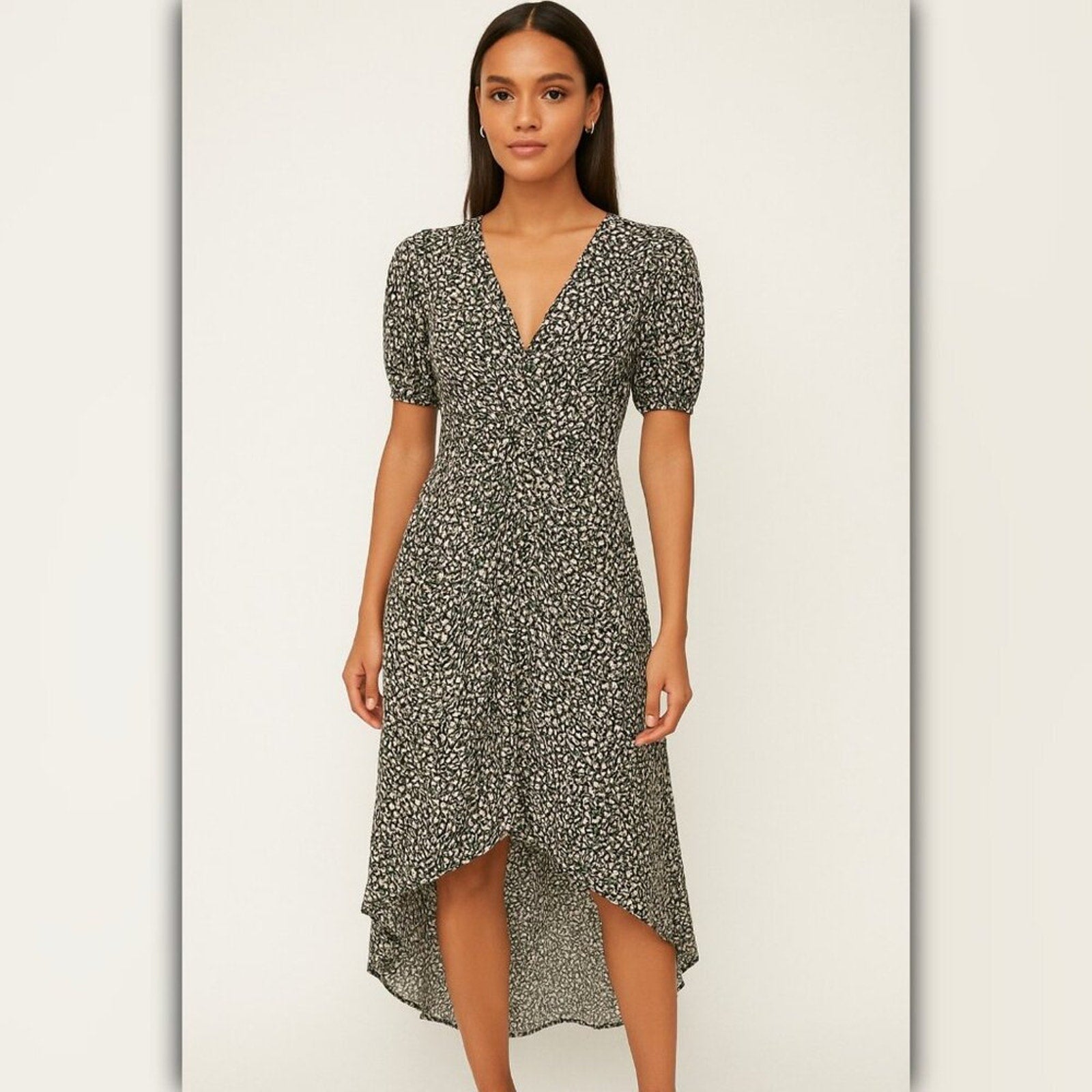 Woman wearing a floral dress on a plain background