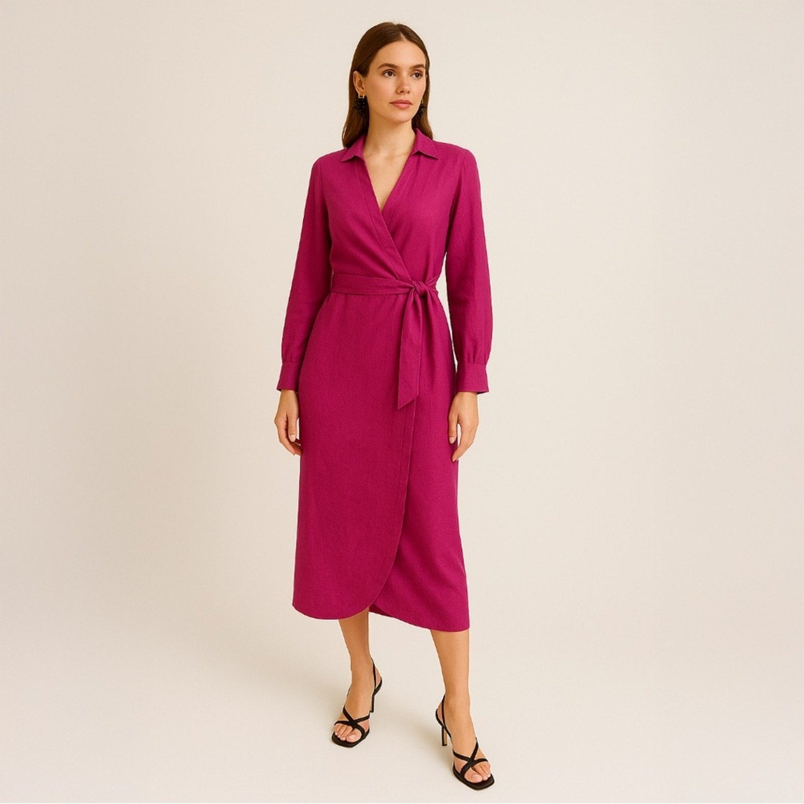 Woman wearing a magenta wrap dress on a beige background