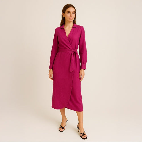 Woman wearing a magenta wrap dress on a beige background