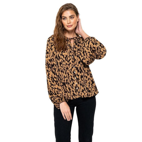Woman wearing a leopard print blouse on a white background