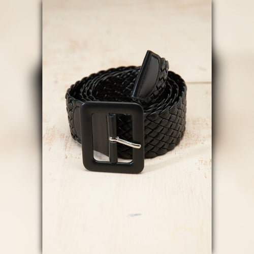 Black braided belt with a black buckle on a beige background