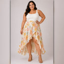 Woman wearing a white top and floral skirt on a plain background