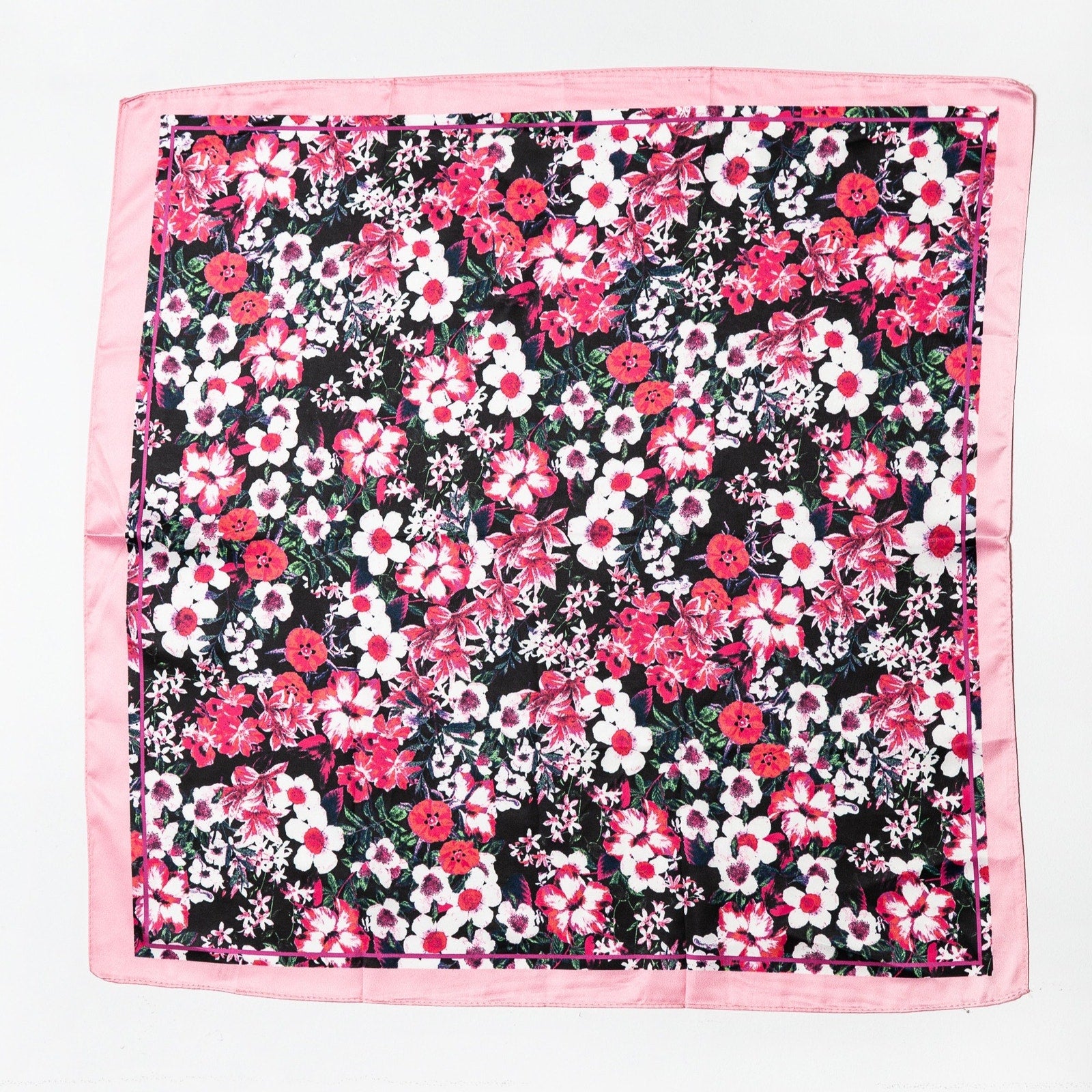 Black satin scarf with pink border featuring dense pink, white, and red floral print laid flat