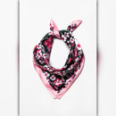Black floral satin scarf with pink trim styled as a neck scarf tied in a knot