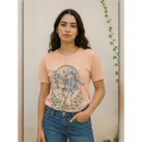 Woman wearing a pink t-shirt with a graphic design against a neutral background