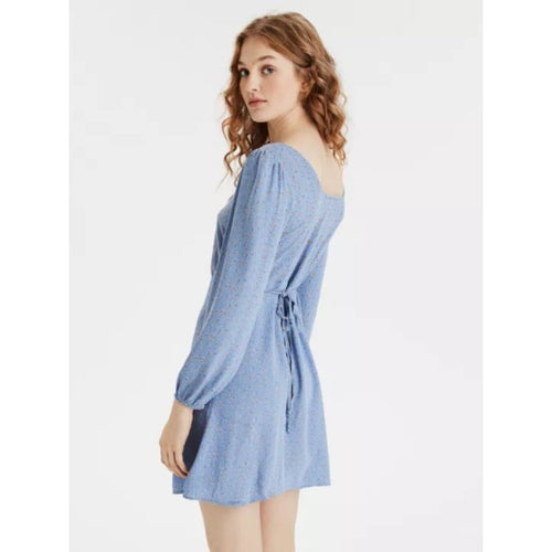 Woman wearing a blue dress on a white background