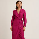 Woman wearing a pink dress against a beige background