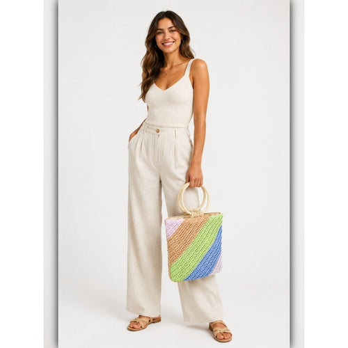 Woman holding a colorful woven bag against a white background
