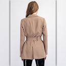 Woman wearing a beige trench coat on a white background