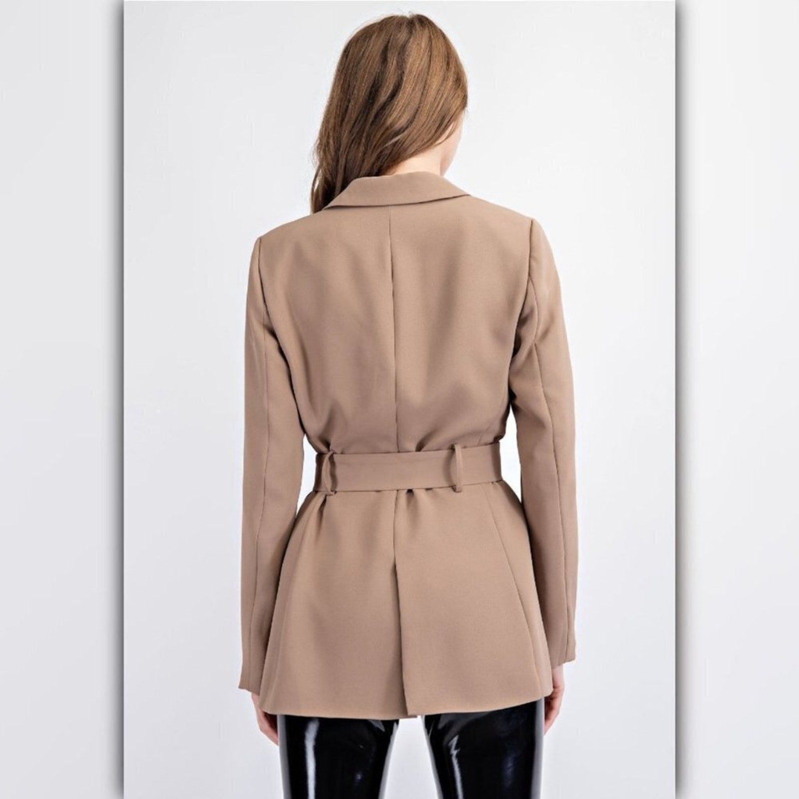 Woman wearing a beige trench coat on a white background